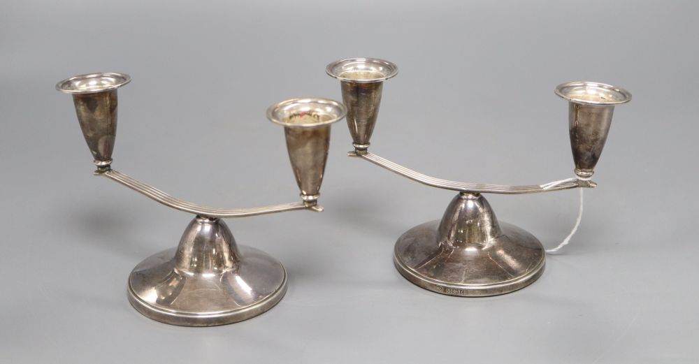 A pair of silver twin branch dwarf candelabra, Adie Bros. Ltd, 1960, loaded, 10.5cm high